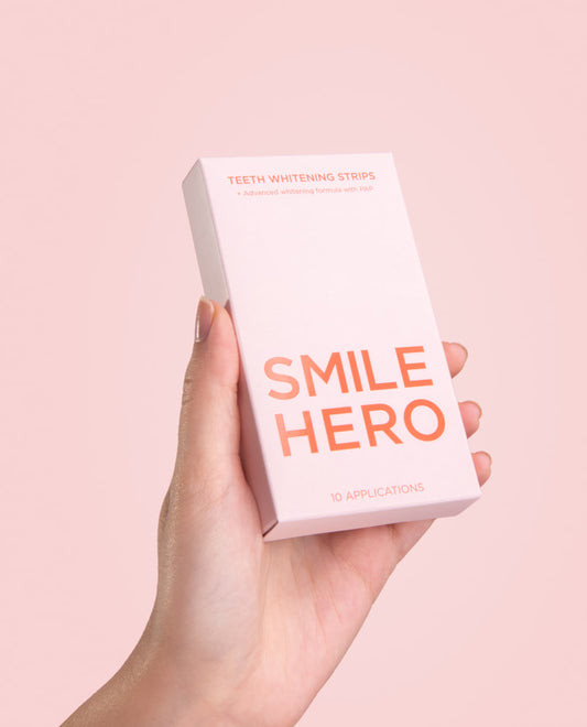 Smile Hero's Teeth Whitening Strips about to be used held by a girls hand at home
