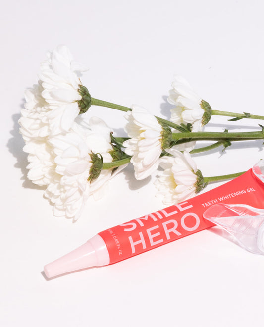 Smile Hero's Teeth Whitening Gel about to be used along side natural flowers and ingredients